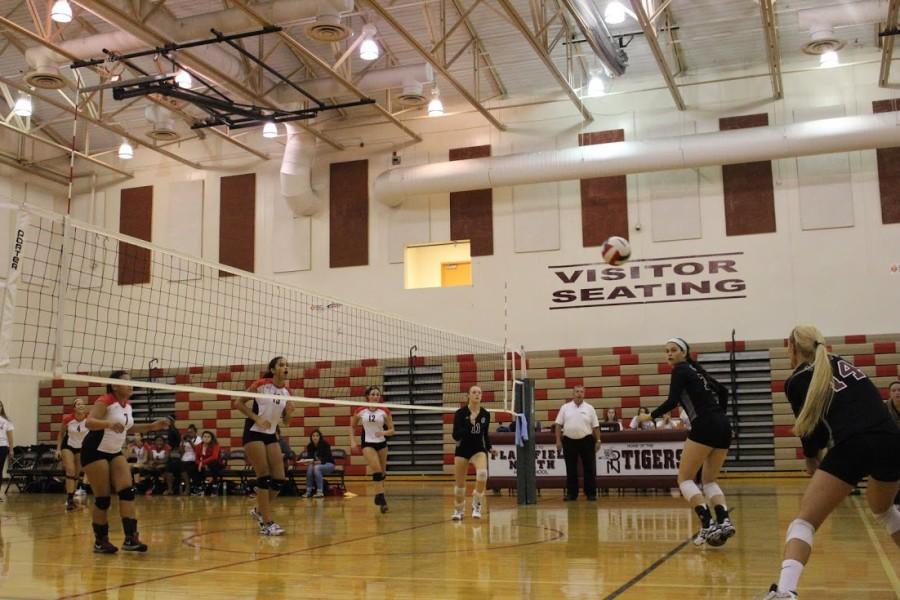 Seniors Lauren Murphy, Lauren Robeck, and Allie Lindroth get ready to set up the next kill in their first tournament game.