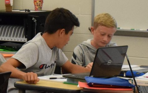 From left: freshman Justin Williams and Sean Elster work together on laptops during their math class. 