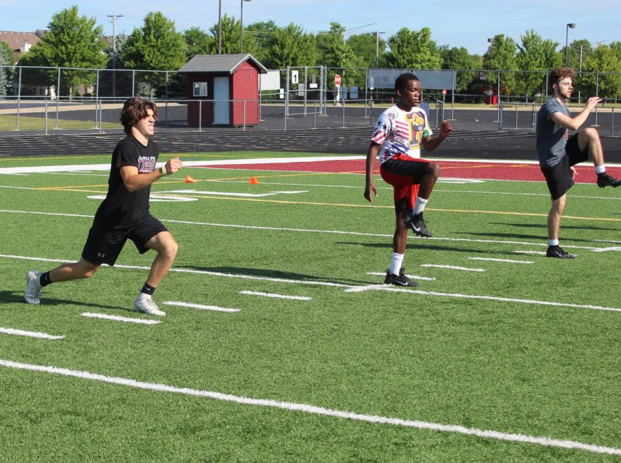 Juniors Dylan Rasmason and Calvin Sharp, and senior Jack Kiefer took part in football drills this summer.