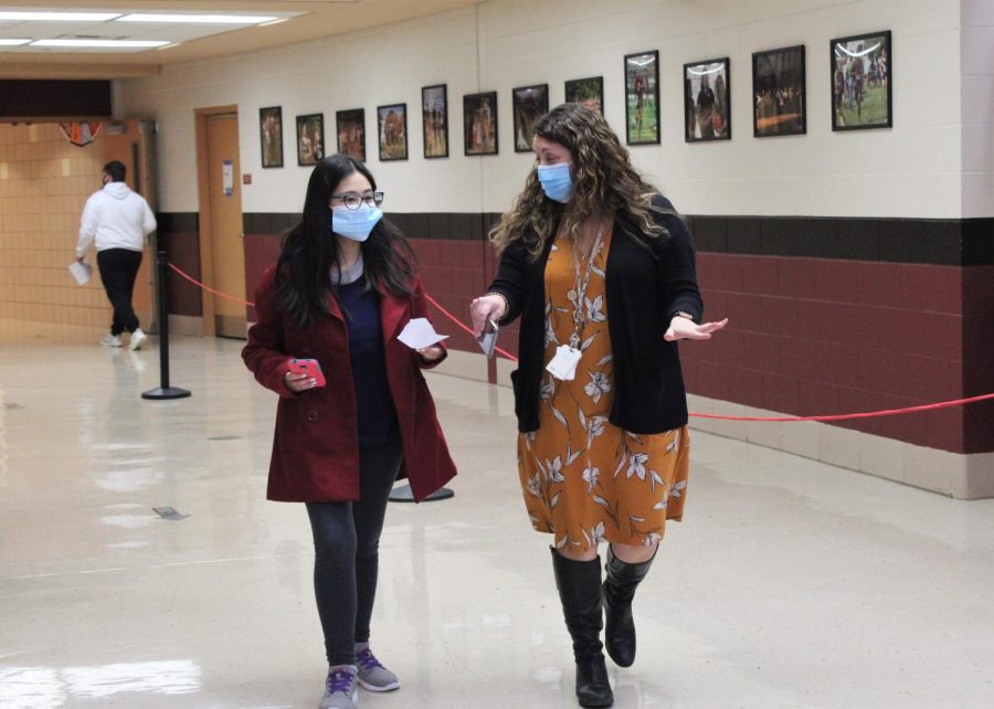 Plainfield North High School Special Education Administrator Shannon McKeague helps a freshman student find her classroom during a Freshman Open House event on Wednesday, January 28, 2021. During Freshman Open House students did a mock walkthrough of their schedules to familiarize themselves with the building.