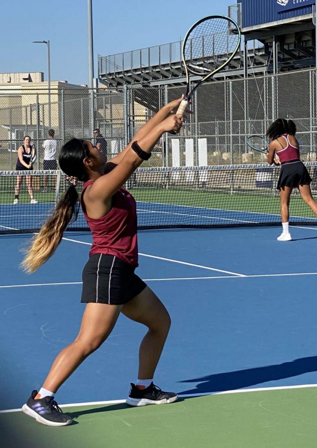 Salcedo serves the ball in a doubles match against Plainfield South. Photo by Adrian Songco