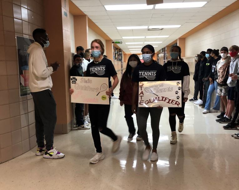 From left: Varsity girls tennis freshmen Jessica Kovalcik, Thea Salcedo and Santoshi Yadagari along with senior Isabela Person walk in a drum line through the halls on Oct. 20 as recognition for qualifiying for the state tournament. Kovalcik finished 3rd place at state in Class 2A. The North team finished 8th place in final standings. Photo by Elena Cantu