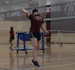 Freshmen Eleanor Corbett prepares to swat the birdie in practice. Photo by Nick Powell