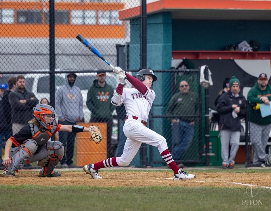 Junior Ryan Nelson launches the baseball with a swing versus Plainfield East on April 5. Photo courtesy of Ted Piton