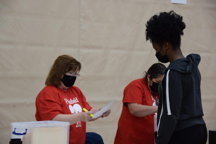 Volunteers Cindy Westfield (left) and Oraluia (right) check-in senior Neze E. Kowa to the Young Heart’s For Life screening.  Photo by Julia Gerard
