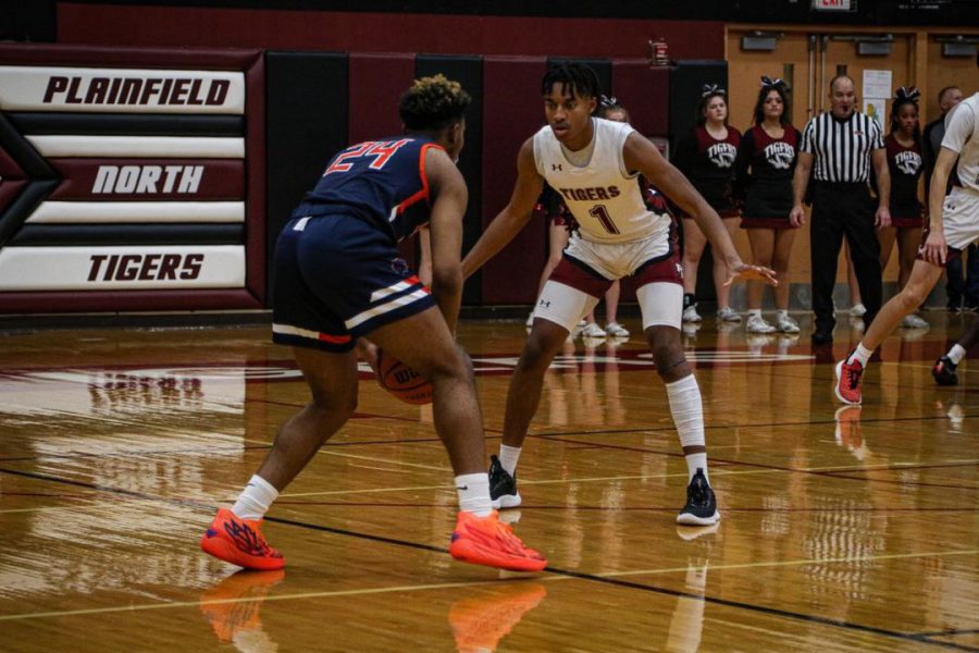 Senior guard Demir Ashiru (right) defends an Oswego player during North’s 65-59 win over the Panthers on Dec 2. 