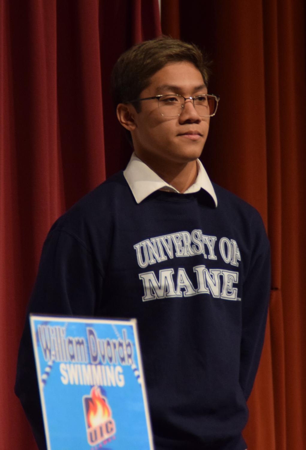 Senior swimmer Ian Mallari signs with the University of Maine on Feb. 1. Photo by Dylan Budd
