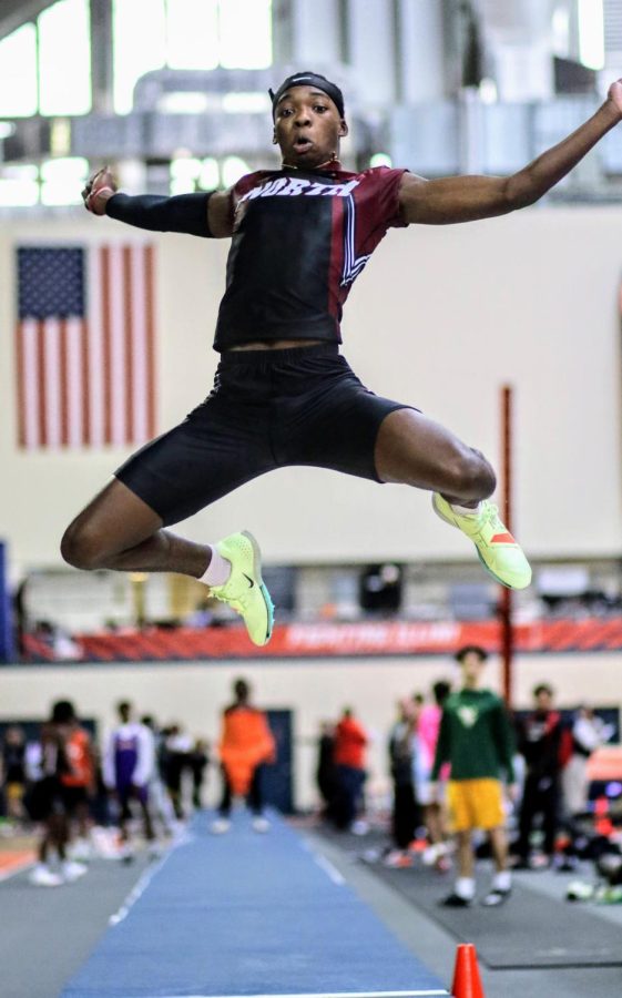 Sophomore Keith Cyracus launches off the board during the long jump event at the First to the Finish invite. Photo courtesy of Tony Holler