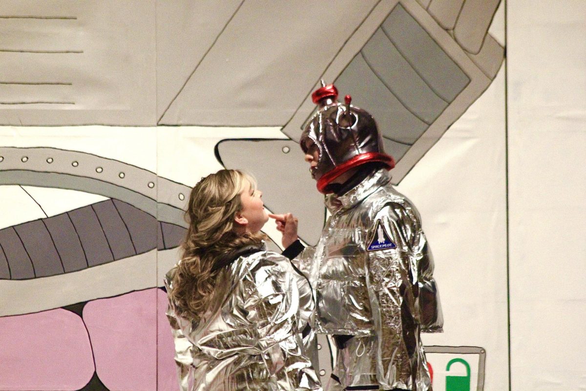 Senior Ella Schuler and sophomore Lily Pyatt perform as Tybalt and Romeo in outer space during a scene from Lucky Spark.