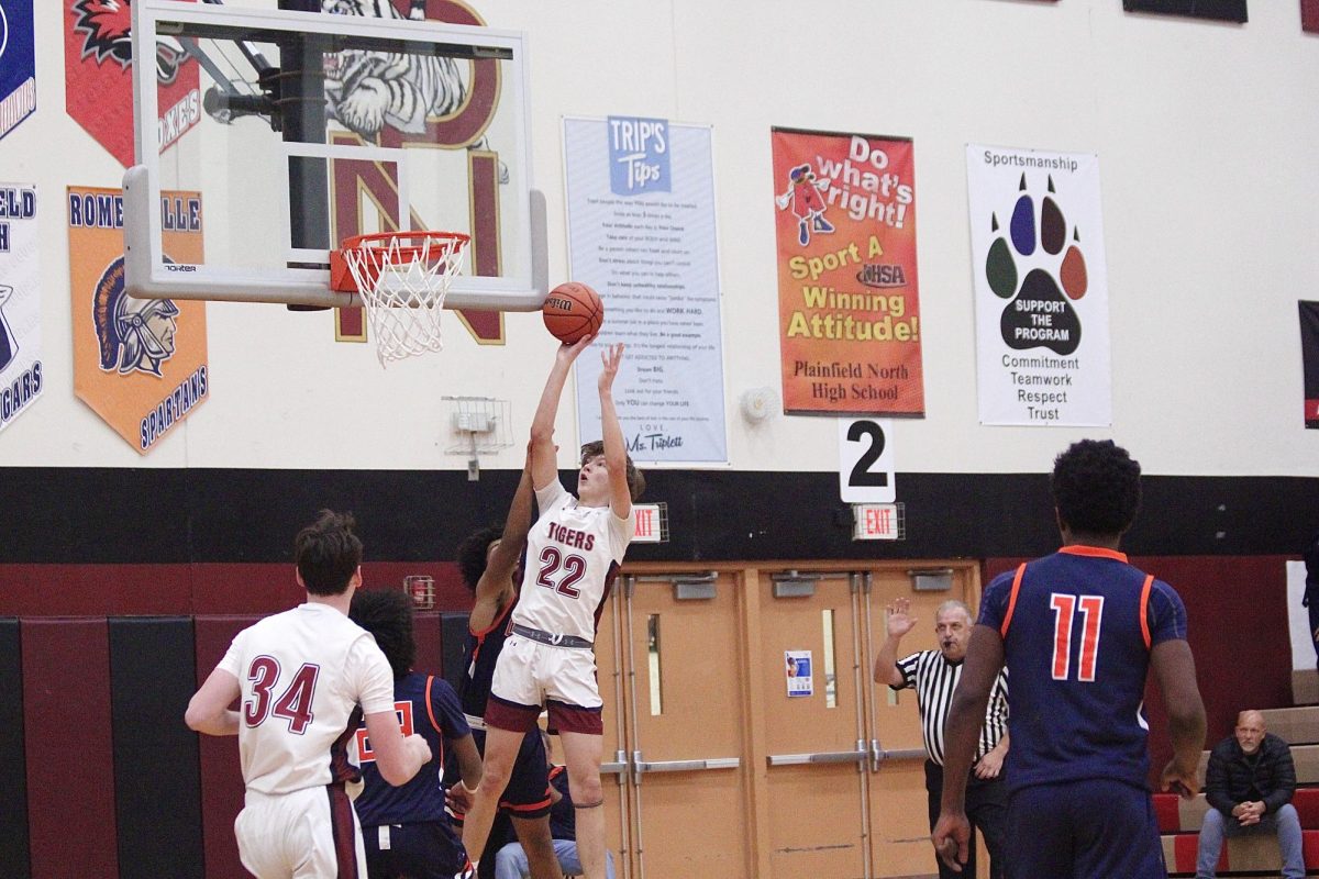 Senior forward Evan Czarnik goes up for the shot as Junior Quintin Wiencek is ready to rebound during the game against Oswego East. 