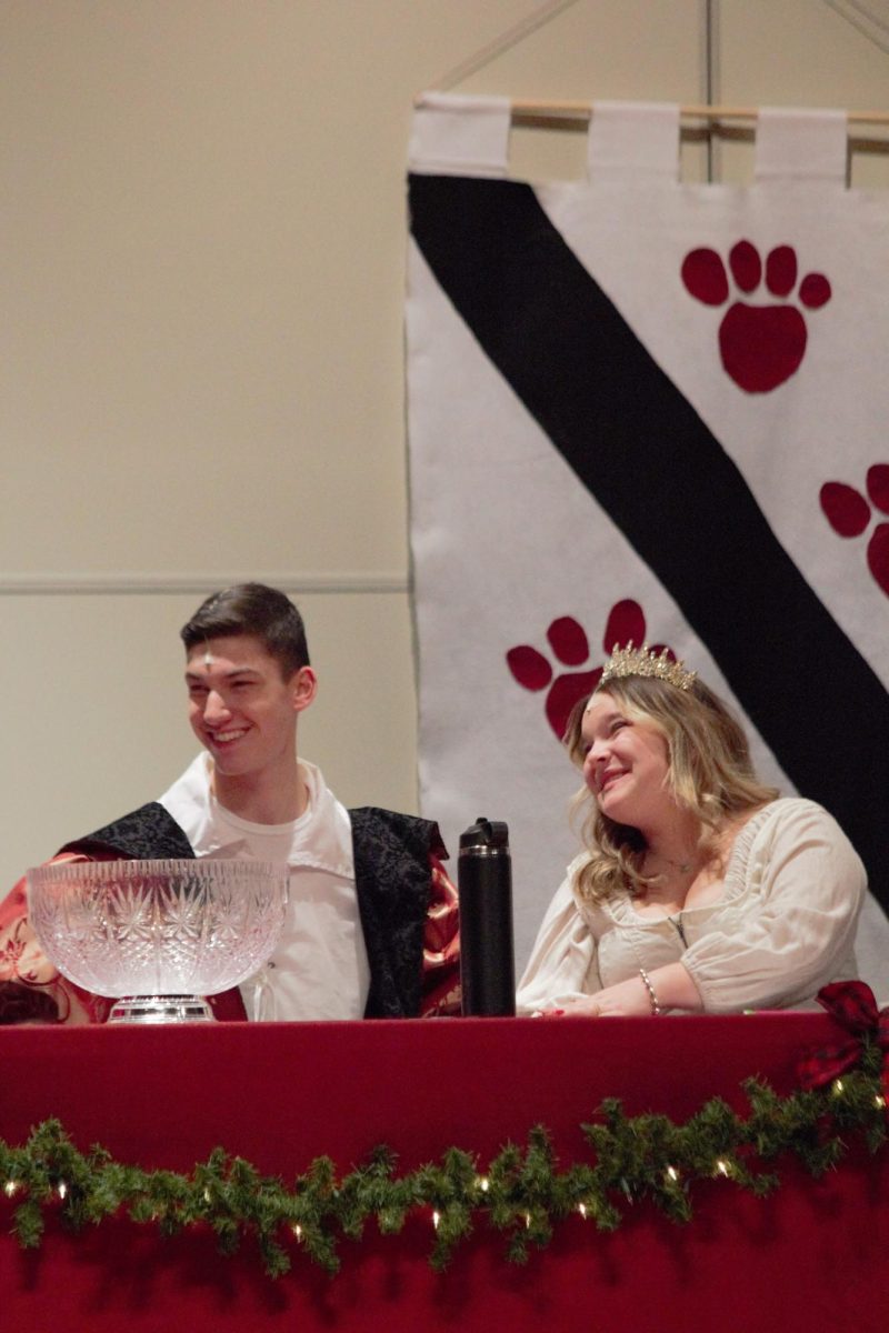 Senior Ben Grobstein and Ella Schuler have a laugh as the king and queen as they host a singing contest.